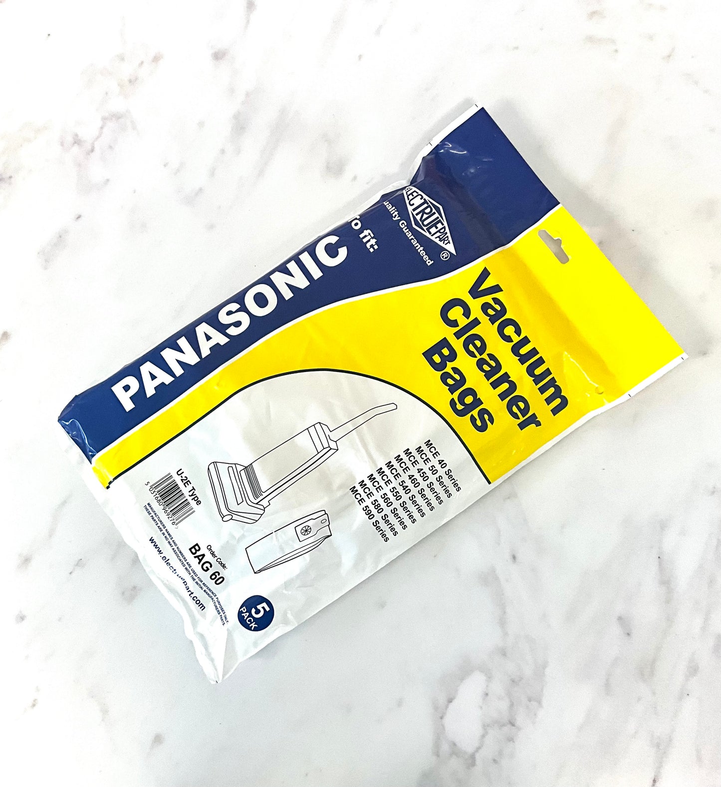 A package of aftermarket Panasonic vacuum cleaner bags by Electruepart, shown on a white marble surface. The packaging is white, yellow, and blue.