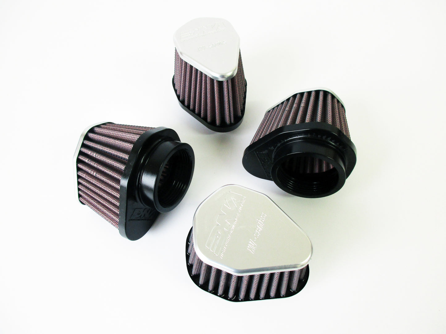 Four universal air filters with grey metal tops and pleated media, arranged on a plain white background.