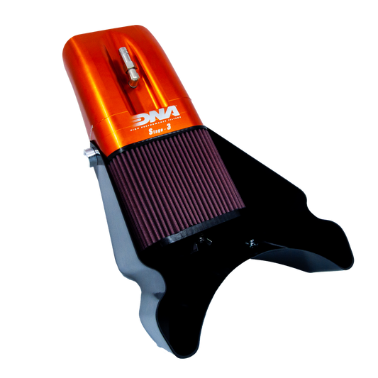 An motorcycle air filter assembly or air box, featuring a metallic orange top section with a grey metal valve and white 'DNA' branding, a dark red pleated filter element, and a black mounting base, shown on a white background.