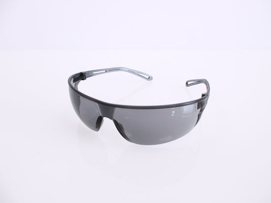 Shield-style safety glasses with a dark gray translucent frame and tinted lenses, photographed on a clean white background.