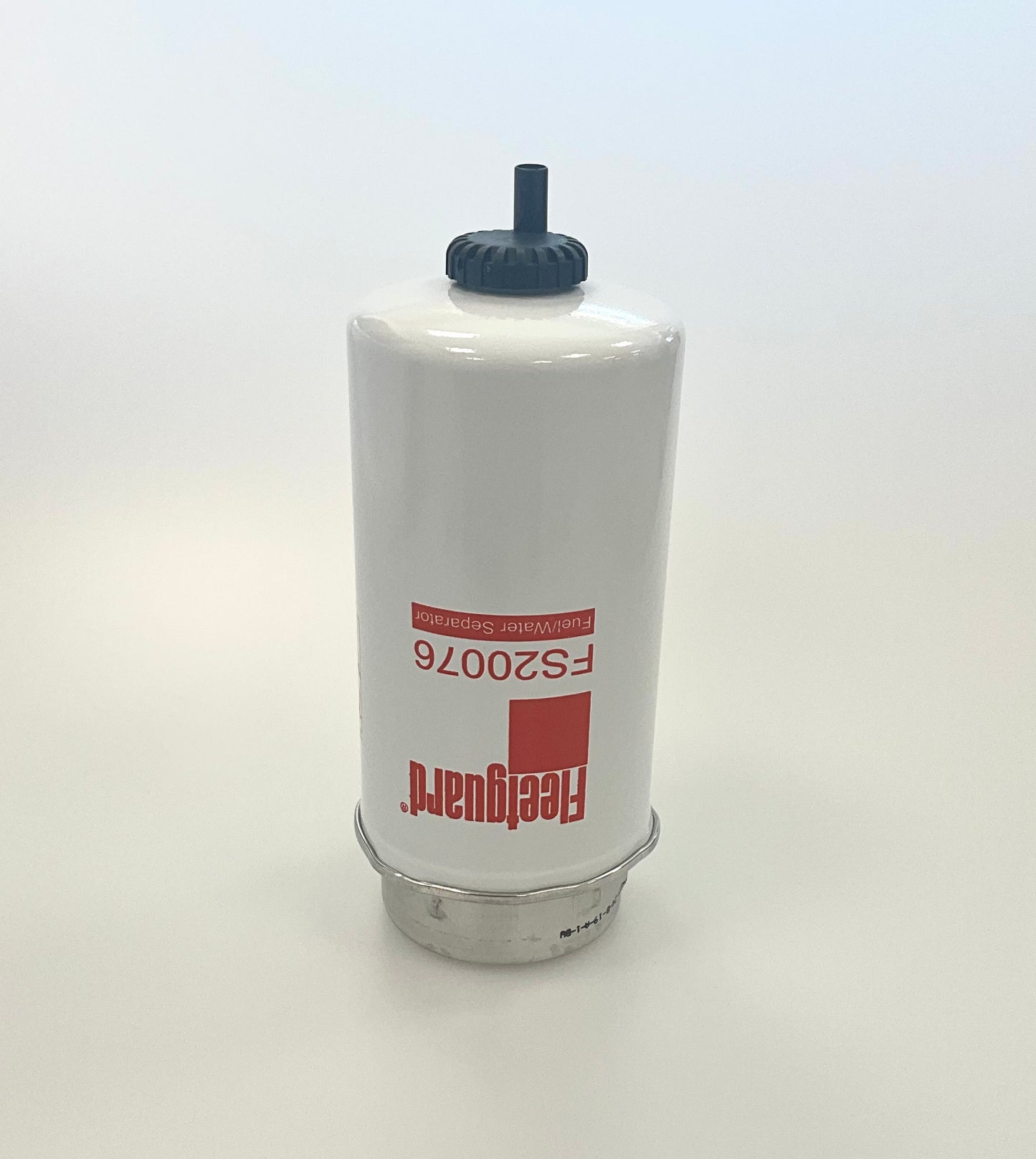 A white cylindrical fuel filter with a black top cap and red printed text reading 'Fleetguard' and 'FS20076', shown on a plain light background.