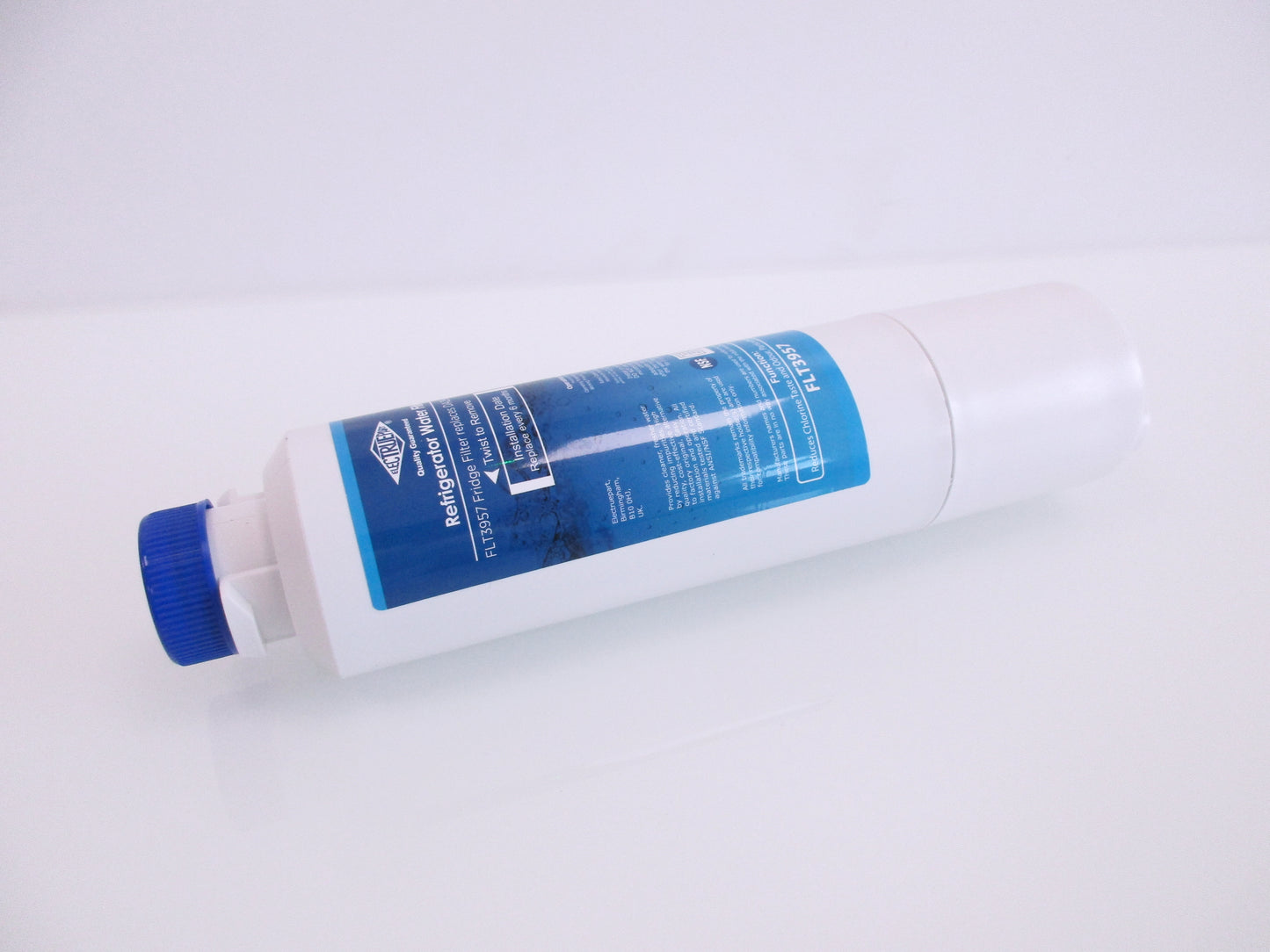 A white cylindrical refrigerator water filter cartridge with a blue cap and a blue label, displaying the part number FTL3957, shown on a plain white background.
