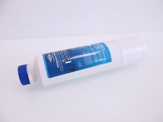 A white cylindrical refrigerator water filter cartridge with a blue cap and a blue label, displaying the part number FTL3957, shown on a plain white background.