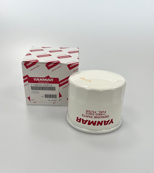 A Yanmar genuine parts fuel filter next to its original white and red packaging box, photographed on a clean white studio background.