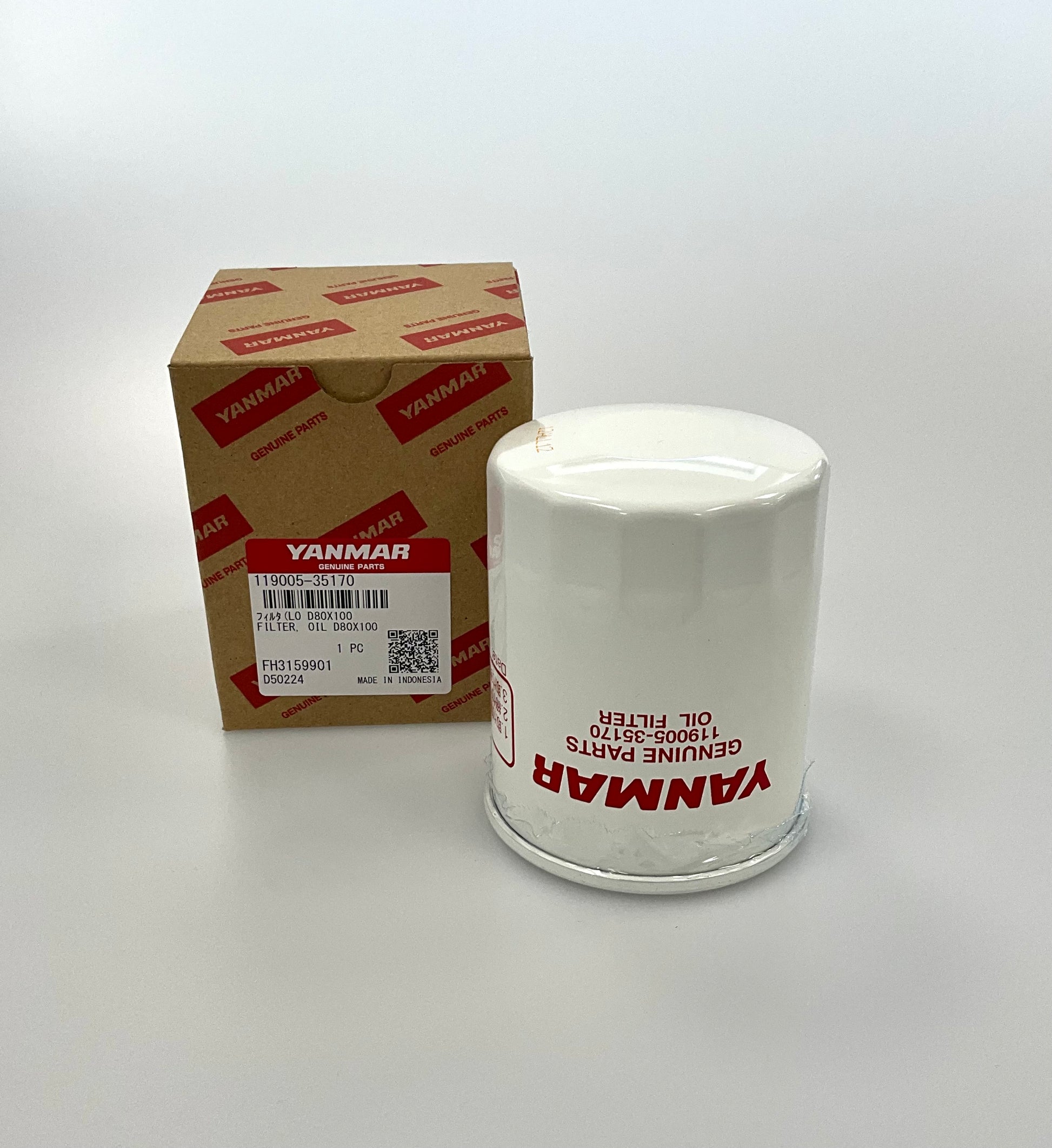 A white Yanmar genuine parts oil filter next to its brown cardboard packaging box with red branding, set against a plain light gray background.