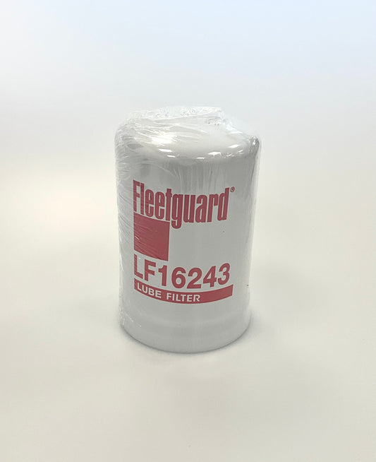 A Fleetguard Lube Filter model LF16243, sealed in clear plastic wrapping with red and black printed branding and text, set against a plain white studio background.