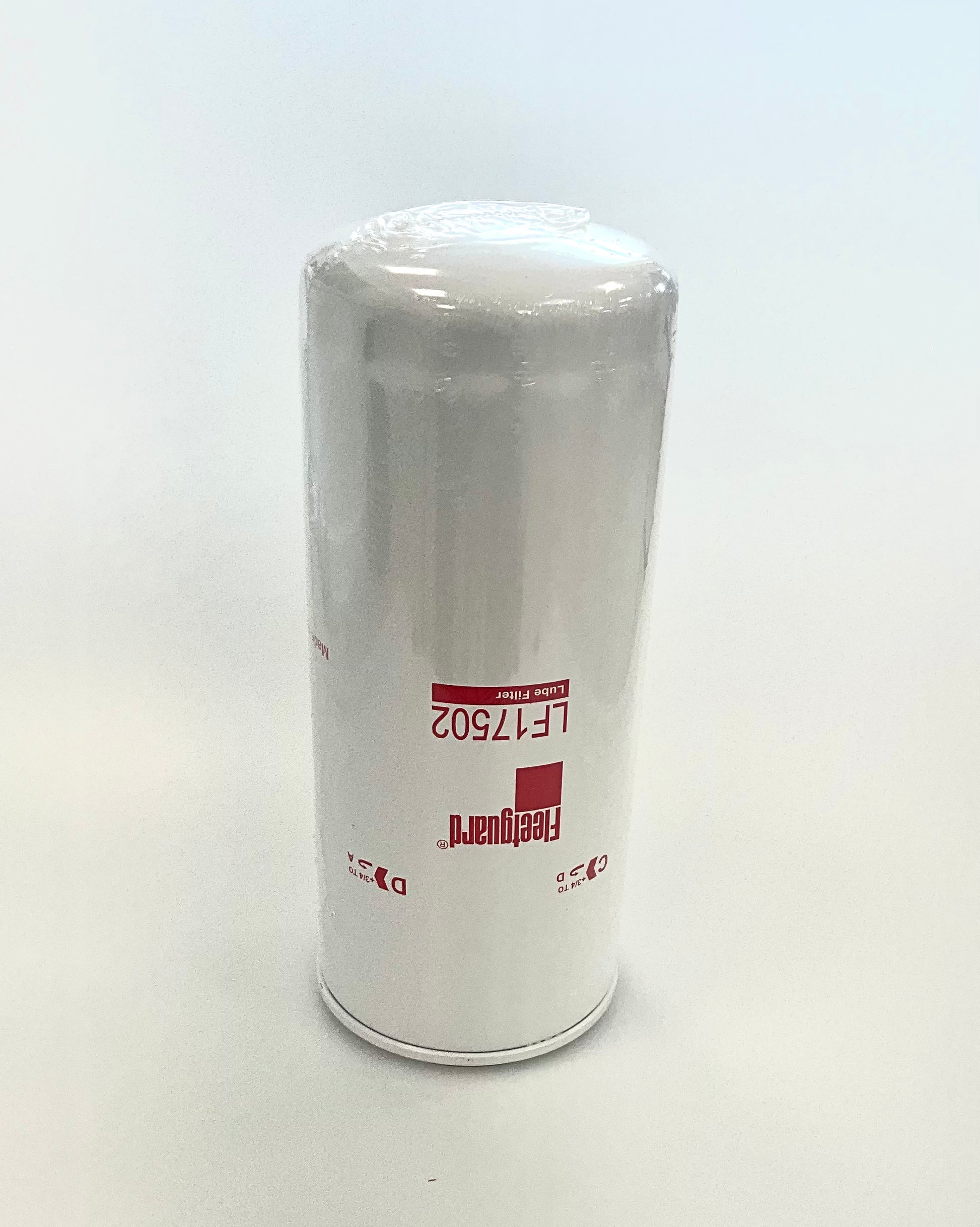 A cylindrical white oil filter spin-on, with red printed text and logo displaying 'Fleetgurad' and 'LF17502', wrapped in protective plastic on a light grey background.