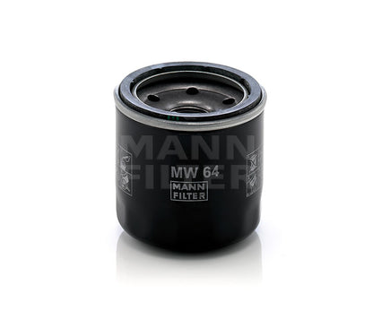 A black cylindrical Mann Filter MW 64 oil filter, with white printed text and logos, shown on a clean white background with a soft reflection.