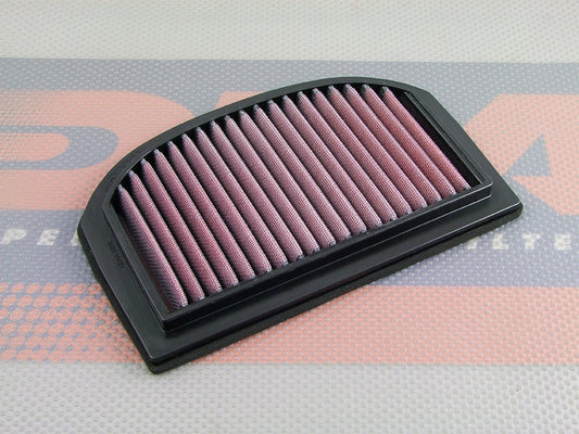 A high performance motorcycle air filter with pleated red media and a black PU frame, resting on a DNA logo themed background.