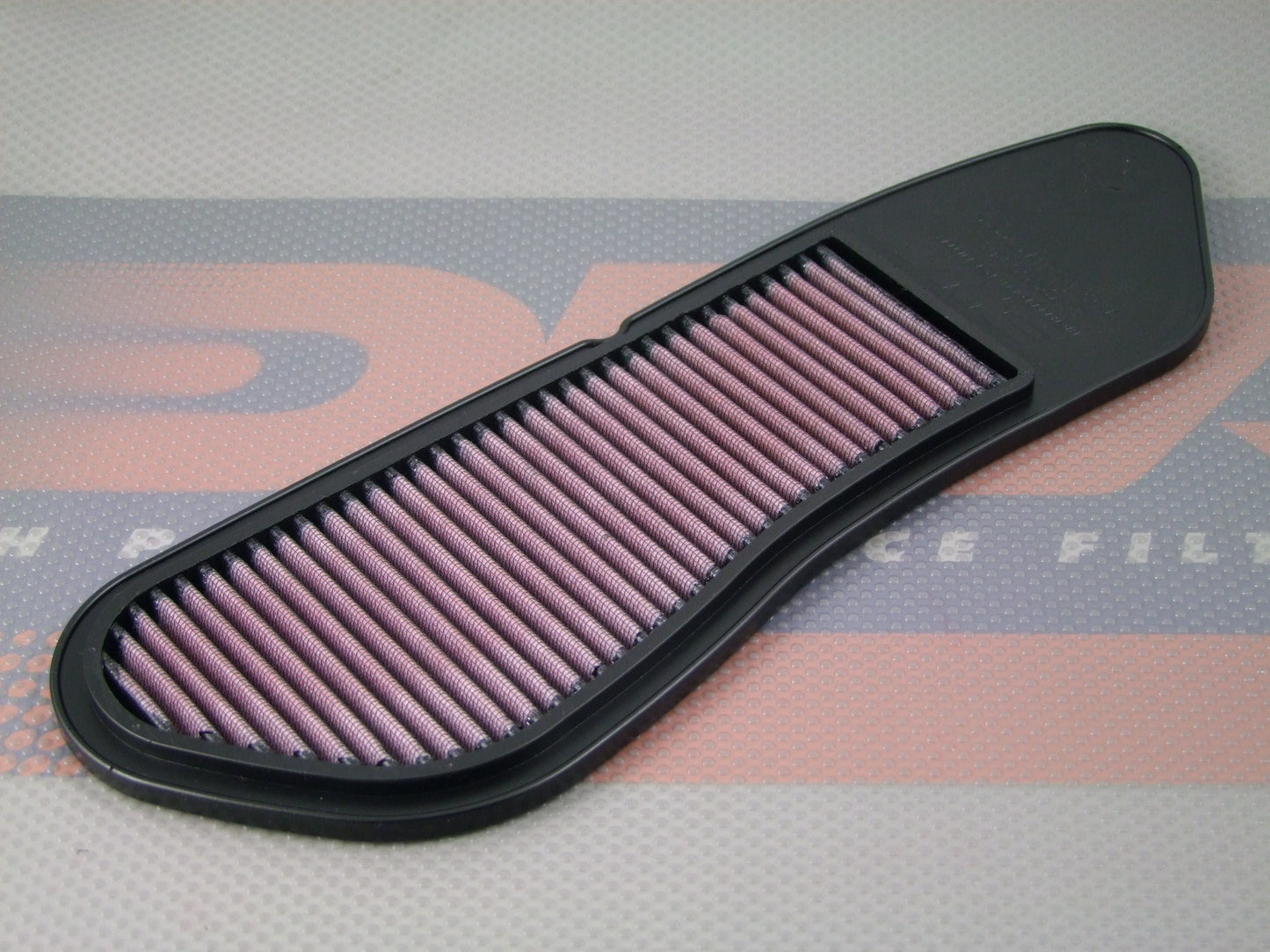 A motorcycle air filter with a black PU frame and pleated media, resting on a DNA logo themed mat