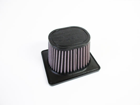 A black oval-shaped motorcycle air filter with pleated filter media and a square black base, photographed on a clean white background.