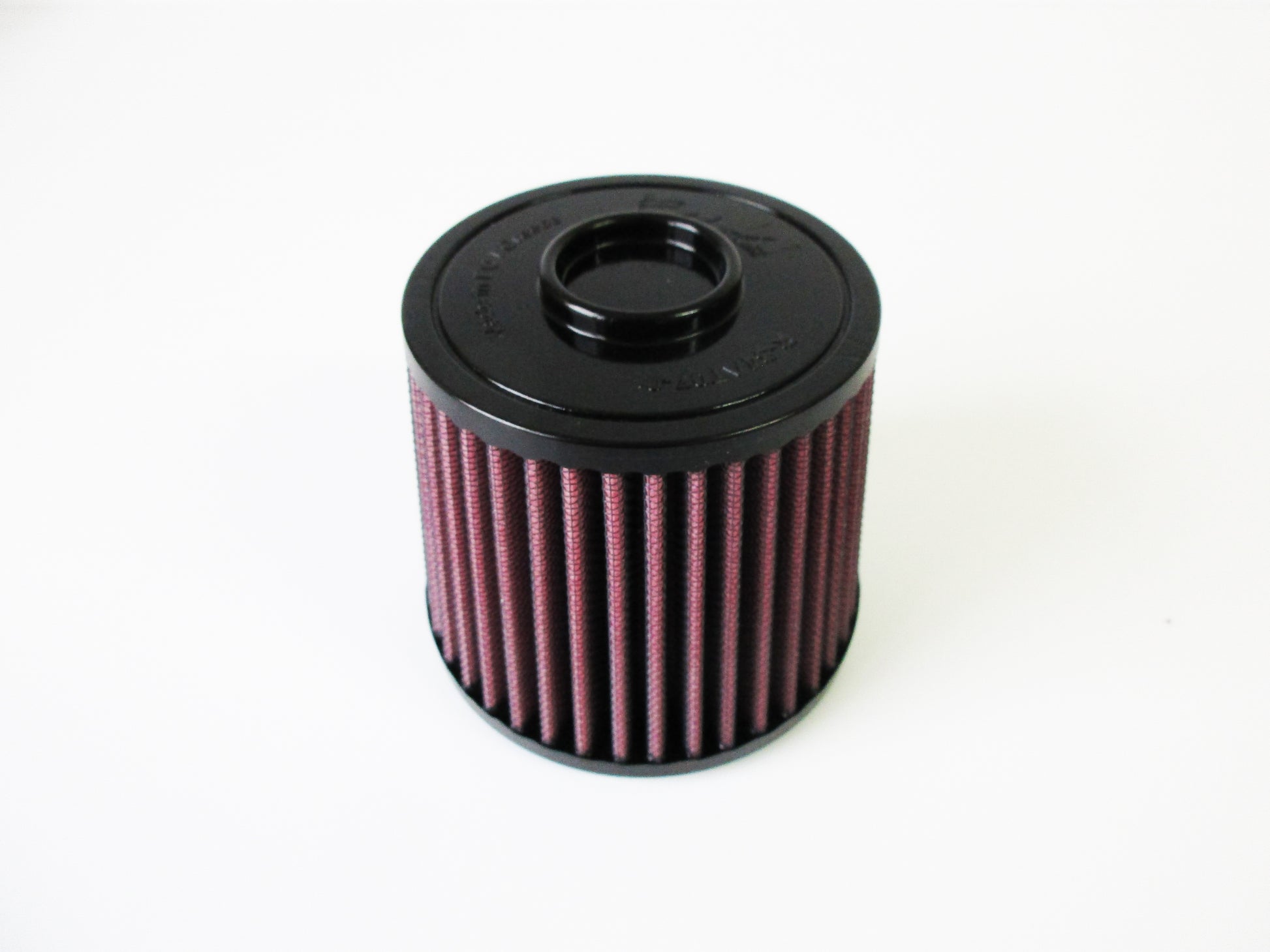A cylindrical motorcycle air filter, with a black top cap and pleated filter media, shown on a plain white background.