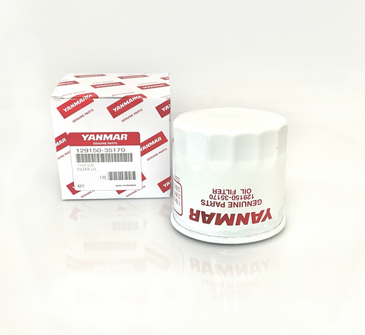 A Yanmar genuine parts oil filter next to its original retail packaging box, displayed on a clean white reflective surface.