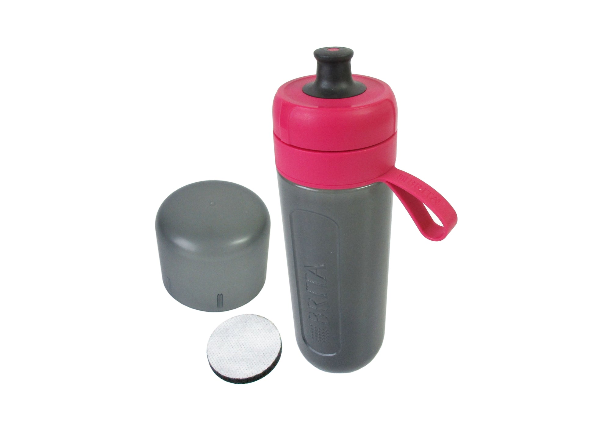 A grey bodied water filter bottle with a bright pink lid, and carrying loop, shown with its grey cap and a round filter disc on a white background.